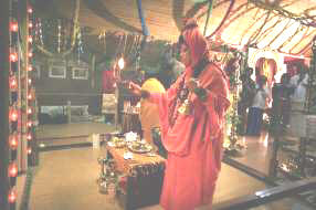 Lalitha Sripalan, dressed in red, performs puja at her temple in Brande, Denmark. Picture: M Q. Fibiger
